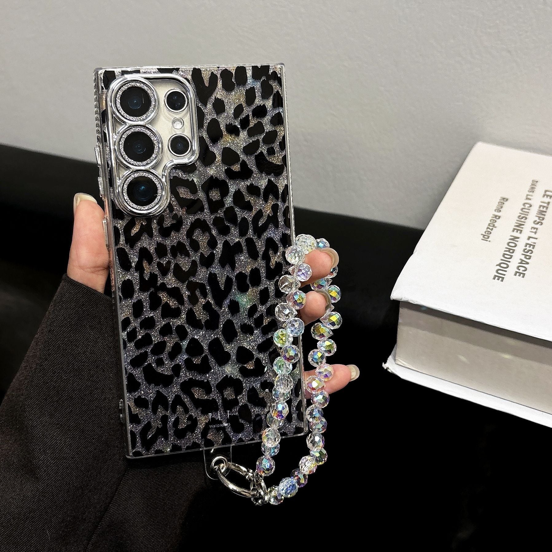 Stylish Cheetah Print Glitter Phone Case for Samsung S24 Ultra - Features detachable wrist strap and shock-absorbent TPU material