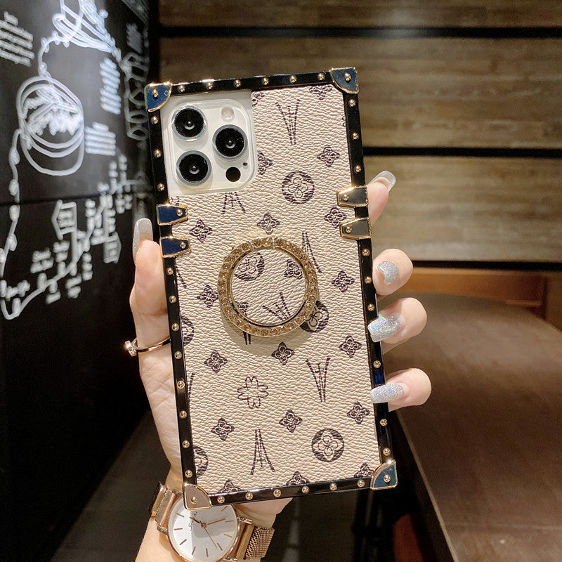 Beige LV-Inspired Trunk Series Phone Case with nostalgic vibe and built-in stand for hands-free convenience
