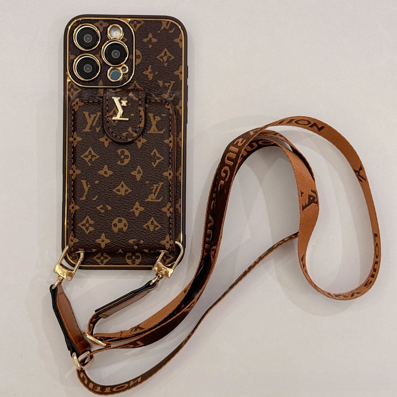Brown LV-inspired wallet phone case with crossbody strap and card holder blending vintage charm with contemporary utility for a boho aesthetic