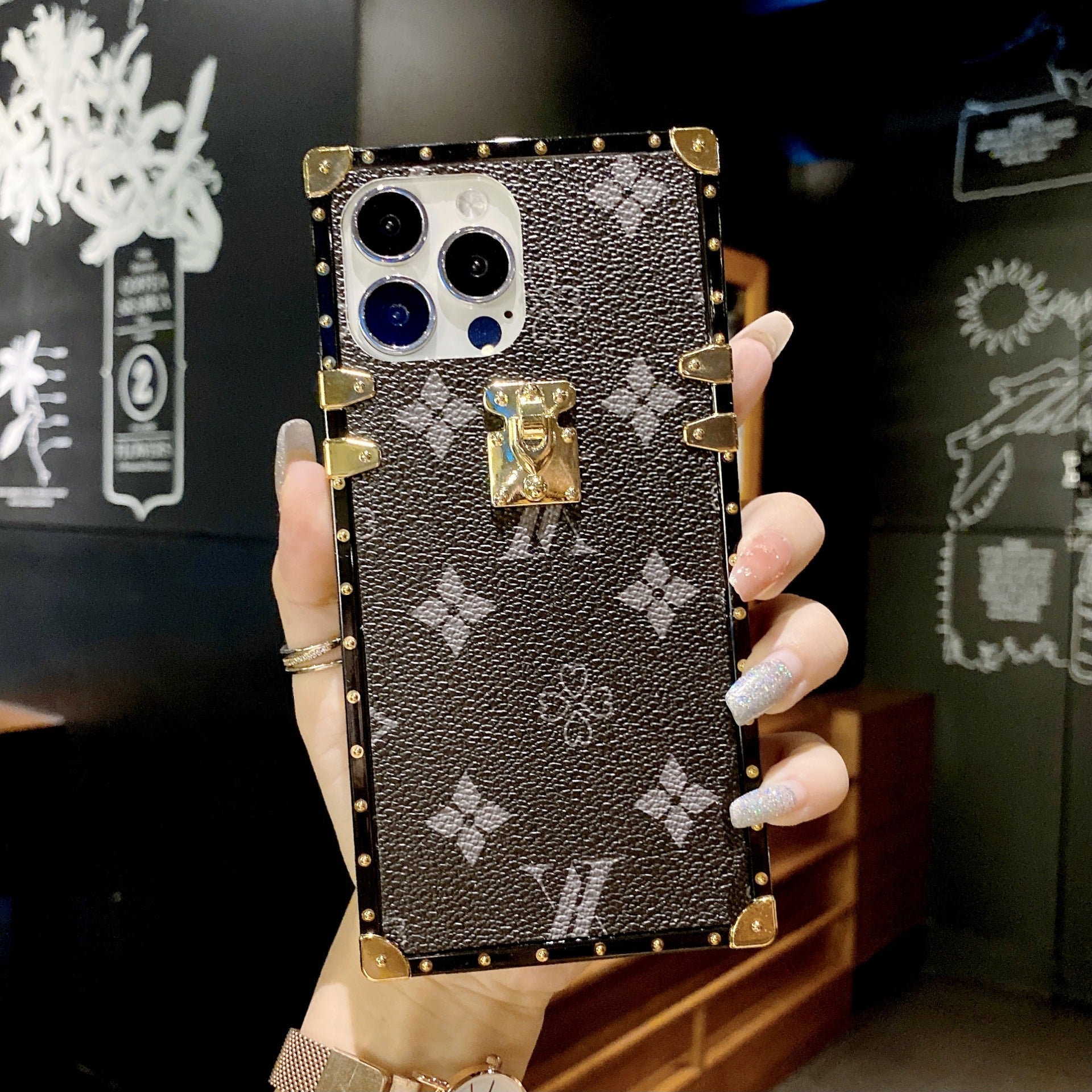 Black LV Trunk Series Phone Case with scratch-resistant matte layer for iPhone and Samsung sleek luxury aesthetic
