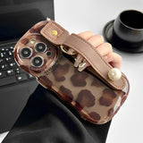 Fashion-forward cheetah print iPhone 14 Plus case with premium leather texture and integrated safety wrist strap