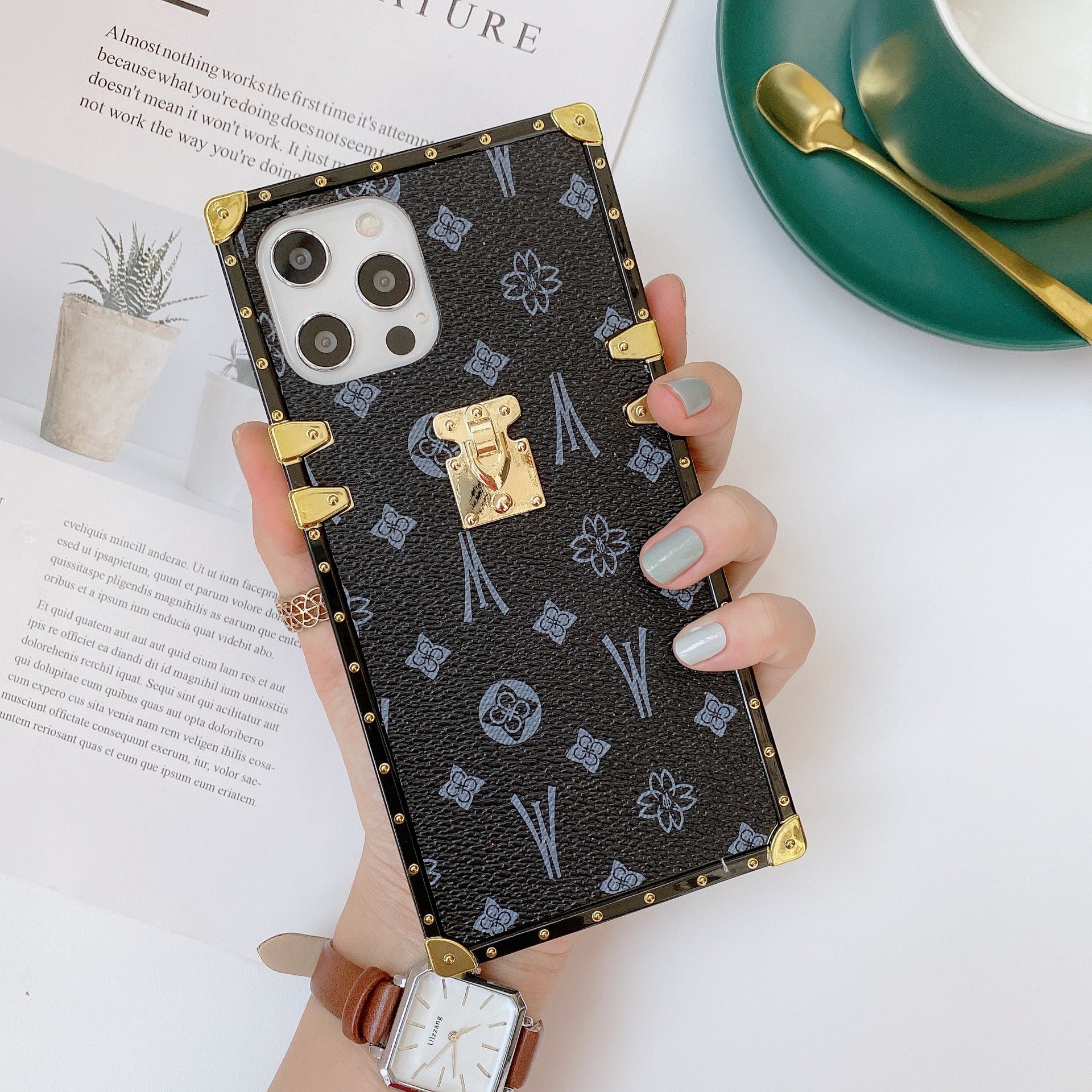 Black LV Trunk Series Phone Case with scratch-resistant matte finish for iPhone and Samsung blending nostalgia with modern chic aesthetic